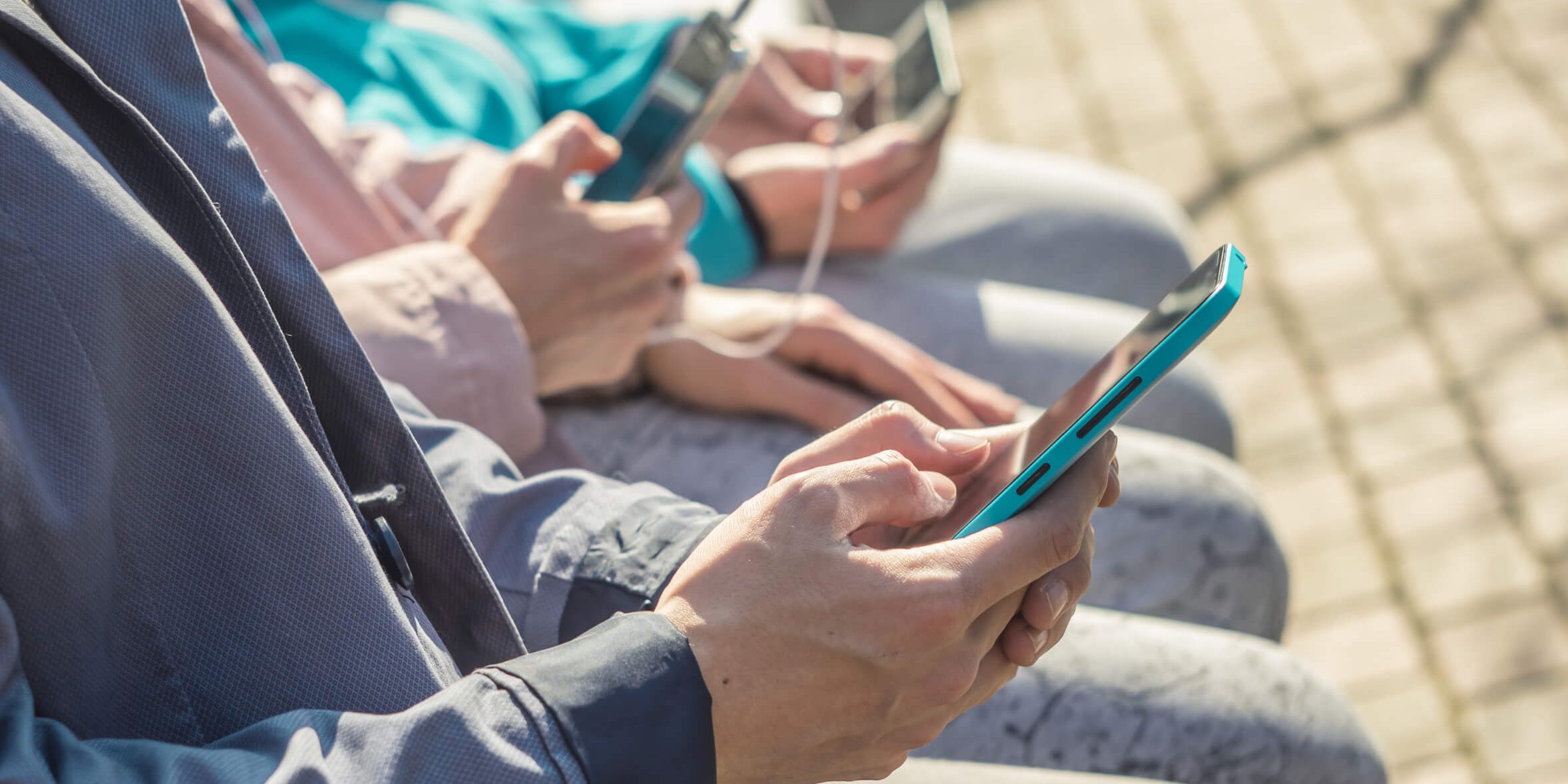 Friends. Hipsters use their phones to chat, online. Teenagers hold smart phones, write messages.