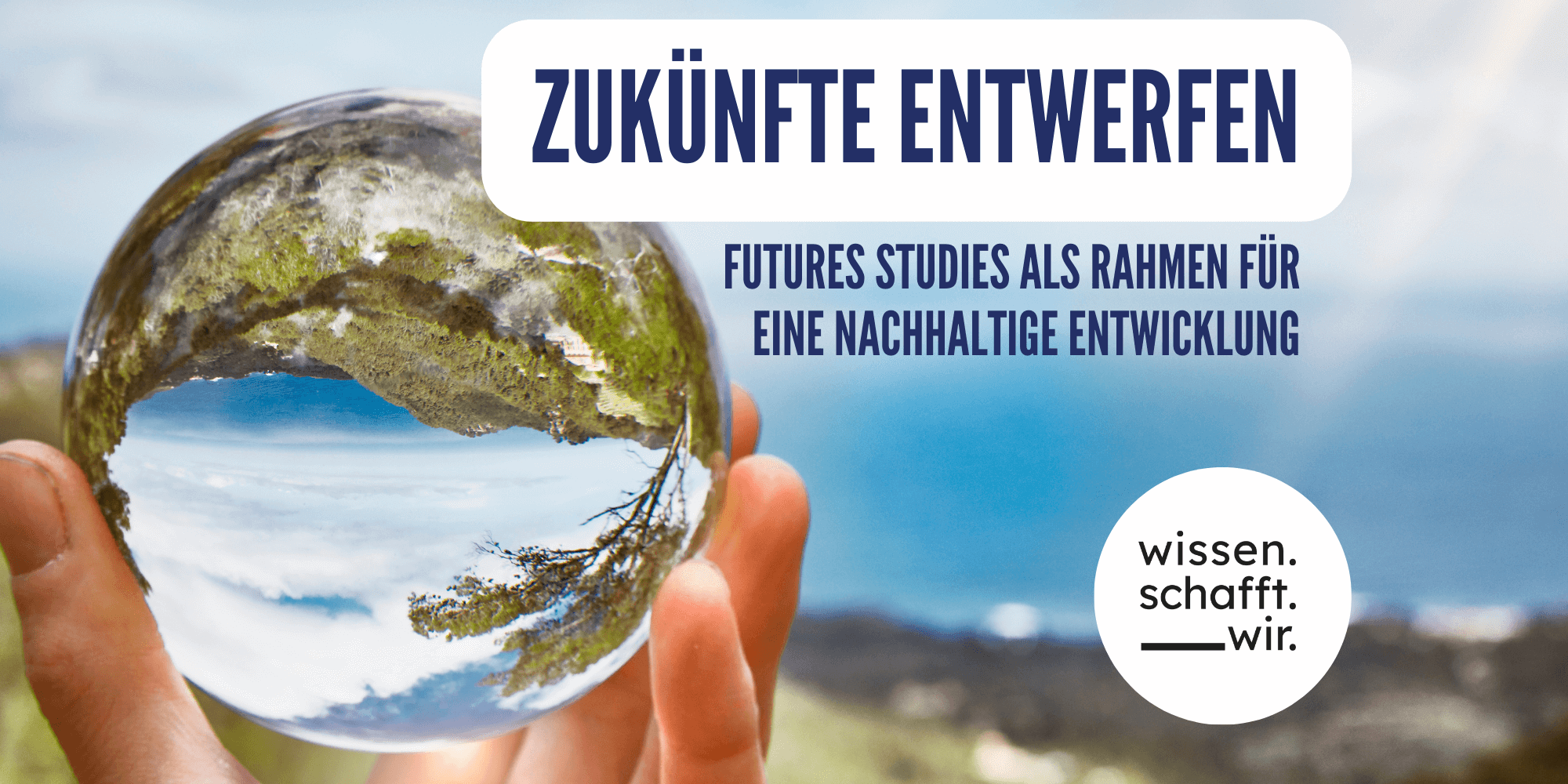 Ein Bild mit einer Glaskugel, in der sich eine grüne Landschaft spiegelt, weist auf die Tagung "Zukünfte entwerfen" hin.